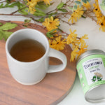 Carmel Berry Elderflower Comfort Herbal Tea tin and mug
