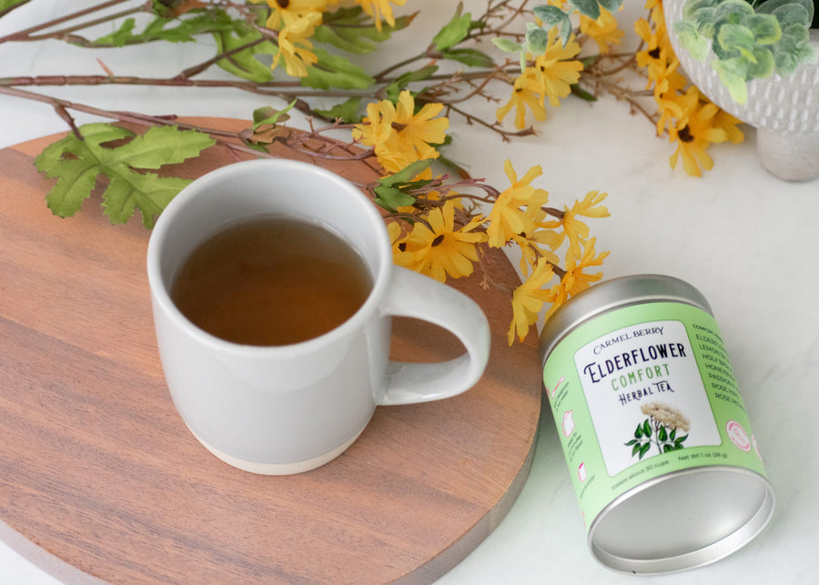 Carmel Berry Elderflower Comfort Herbal Tea tin and mug