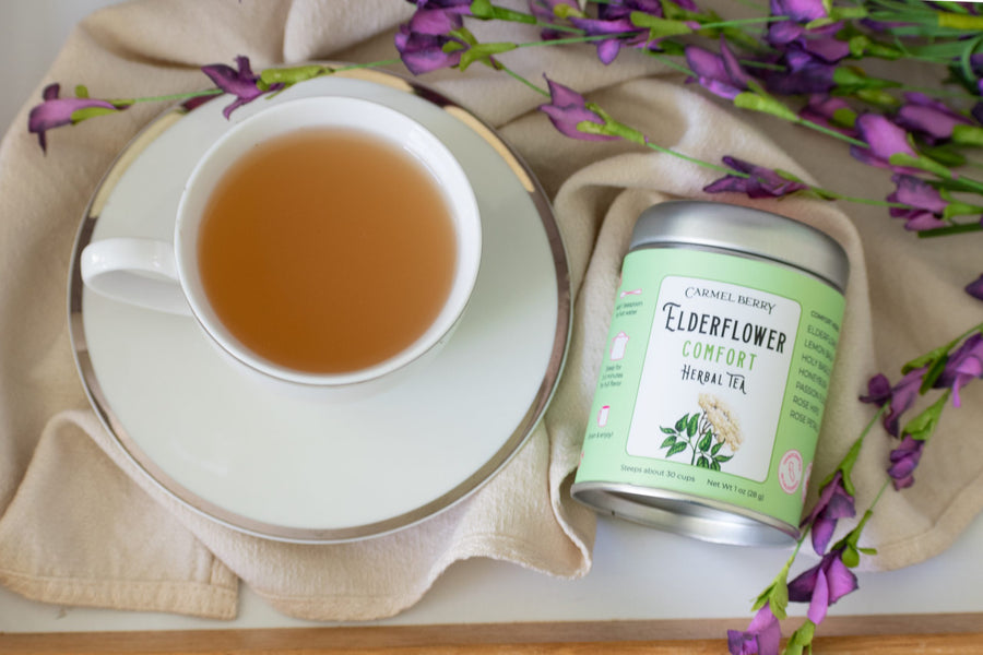 Carmel Berry Elderflower Comfort Herbal Tea tin and tea cup