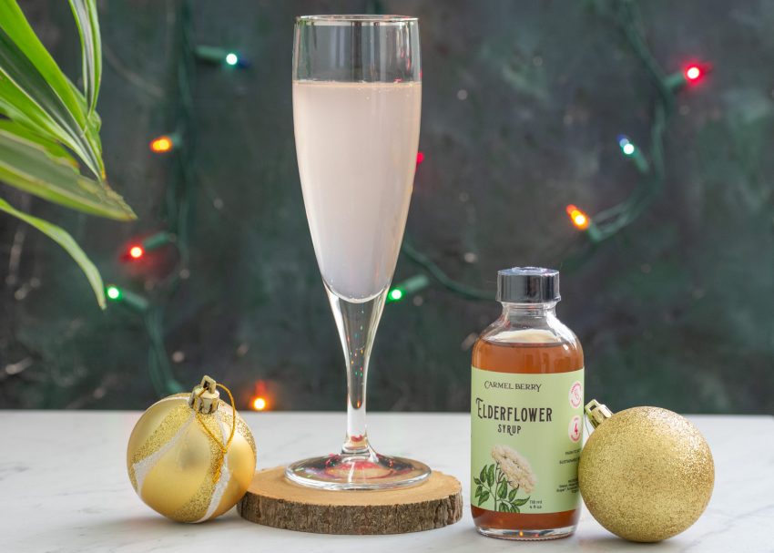 Carmel Berry Elderflower Syrup bottle with mocktail in glass