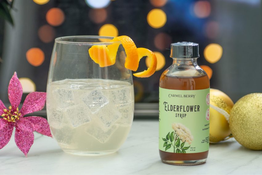 Carmel Berry Elderflower Syrup bottle with mocktail in glass