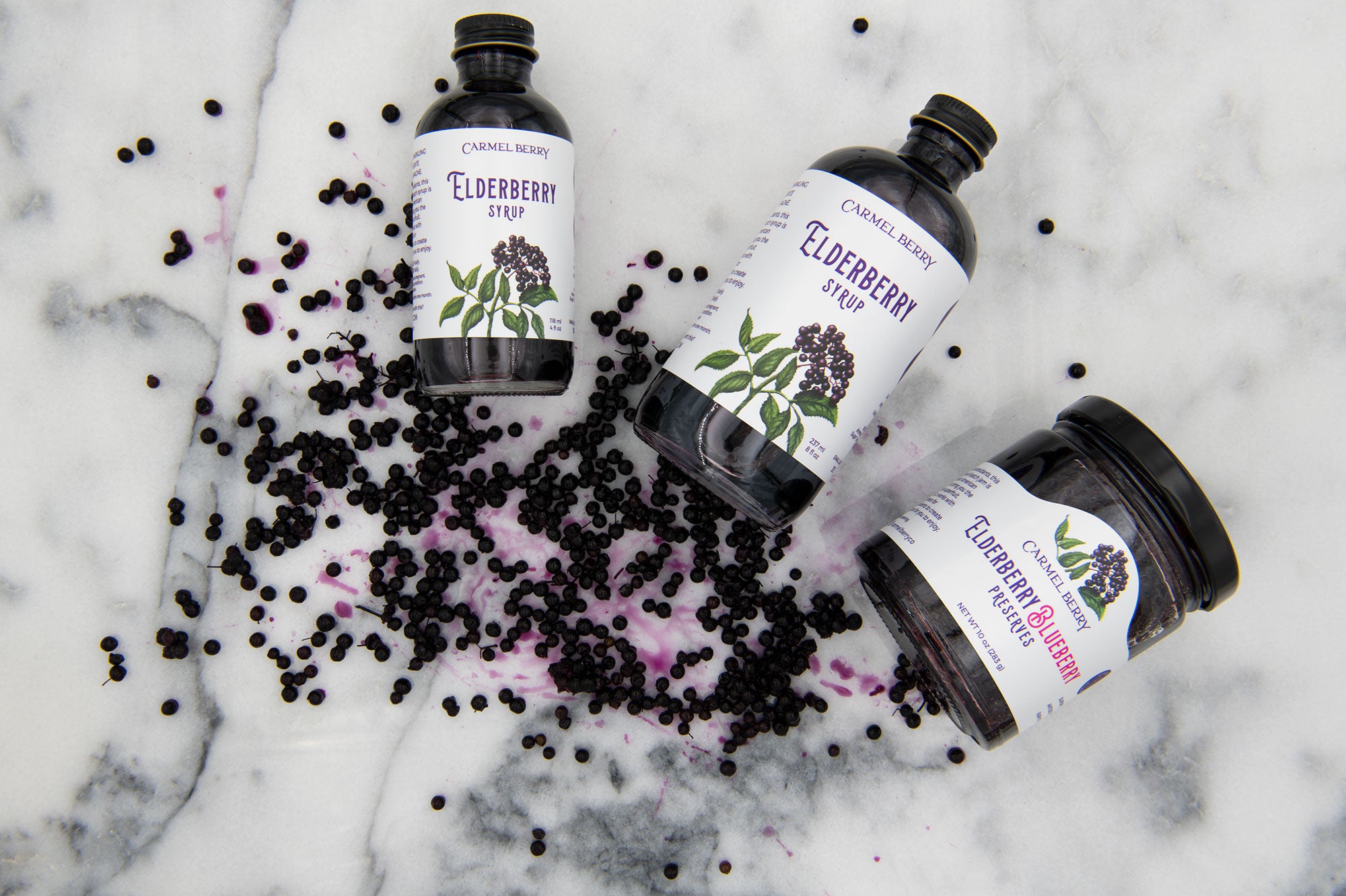 Carmel Berry Elderberry Blueberry Preserves jar and Elderberry syrup bottles